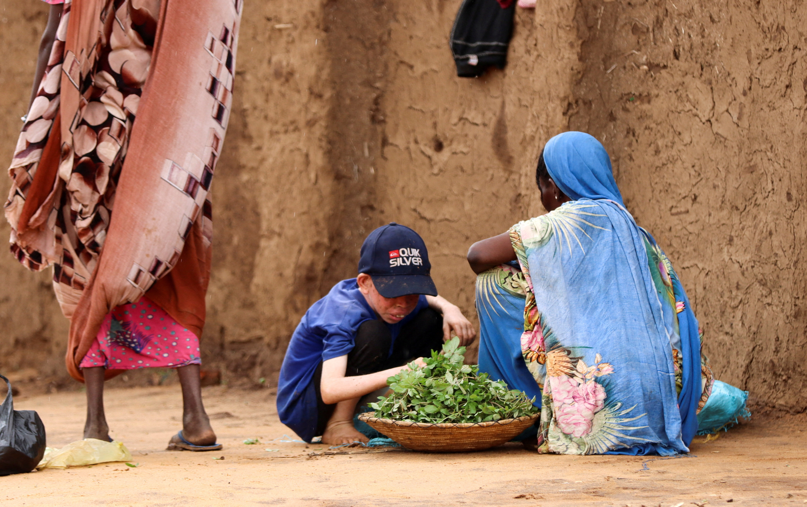 FILE PHOTO: Displaced Sudanese people sit at Zamzam camp in North Darfur