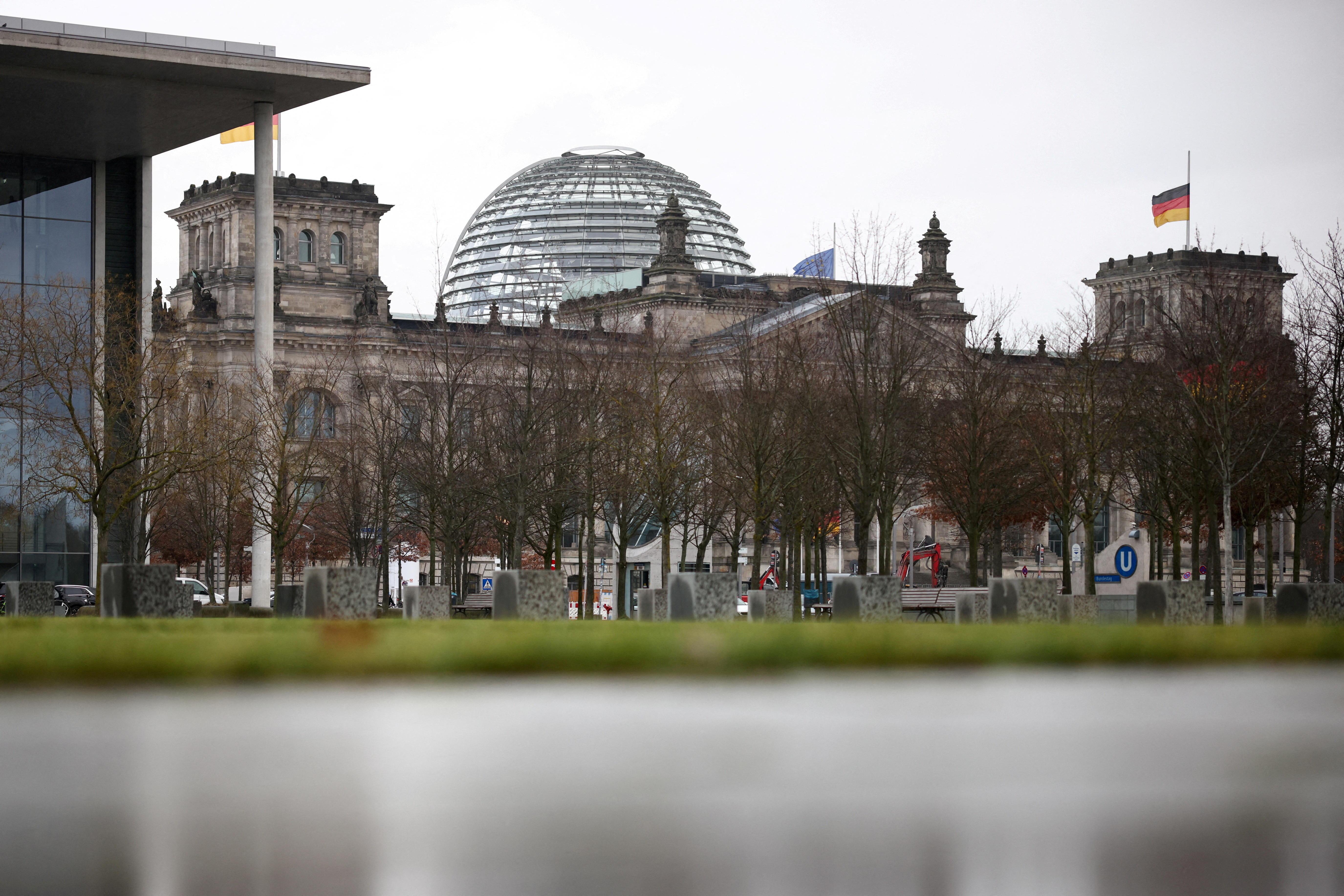 FILE PHOTO: German flag hangs at half-mast atop of the Reichstag building in Berlin