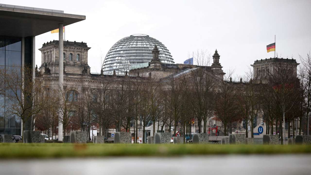 FILE PHOTO: German flag hangs at half-mast atop of the Reichstag building in Berlin