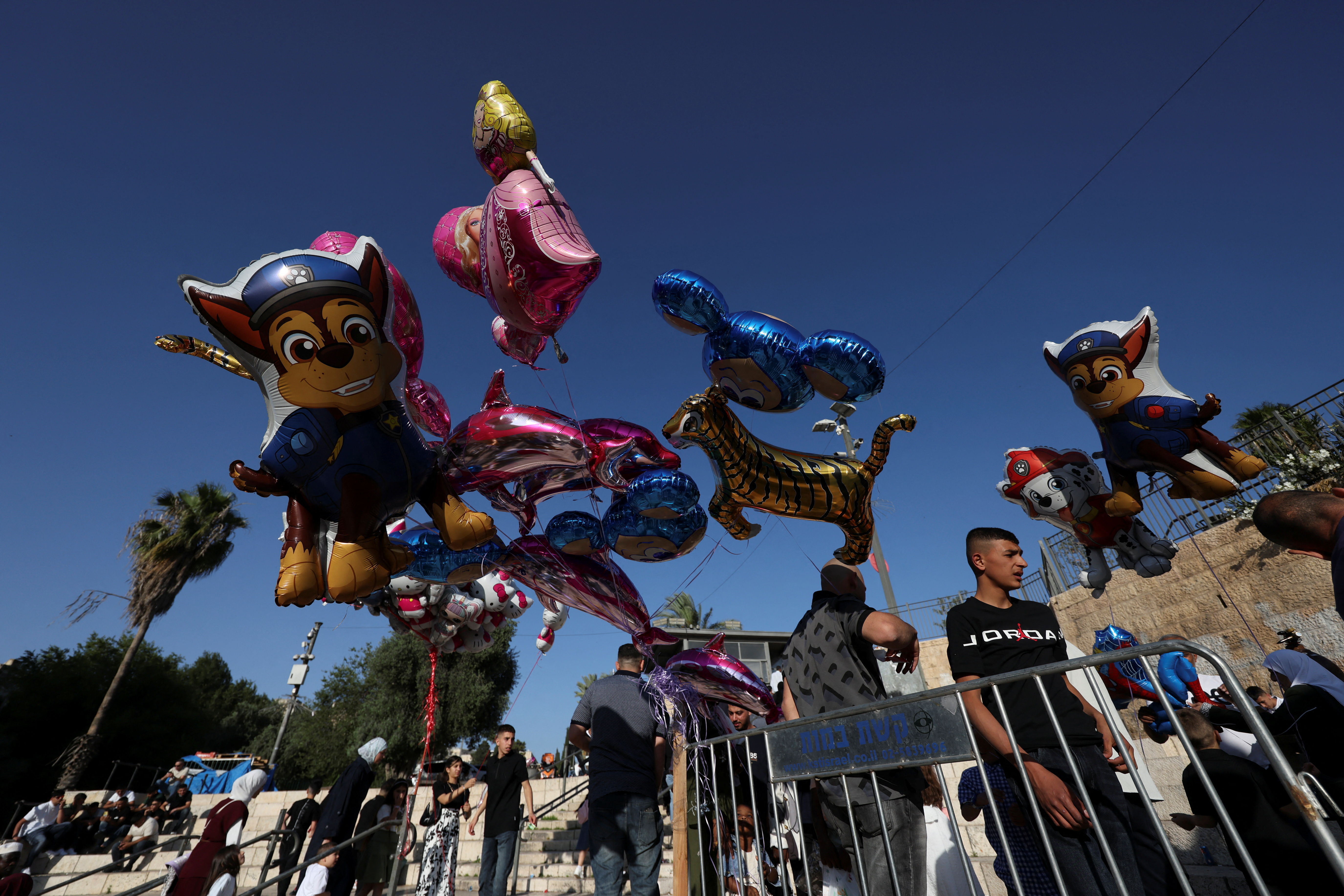 People gather near the Damascus gate on the first day of the Muslim holiday of Eid al-Adha, in Jerusalem's Old City