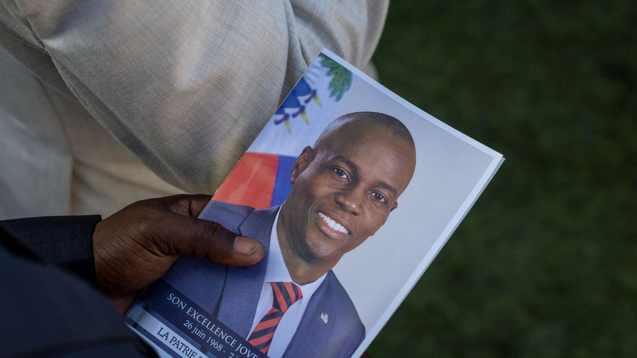 File photo: A person holds a photo of late Haitian President Jovenel Moise, who was shot dead earlier this month, during his funeral at his family home in Cap-Haitien, Haiti, July 23, 2021. REUTERS/Ricardo Arduengo/File photo