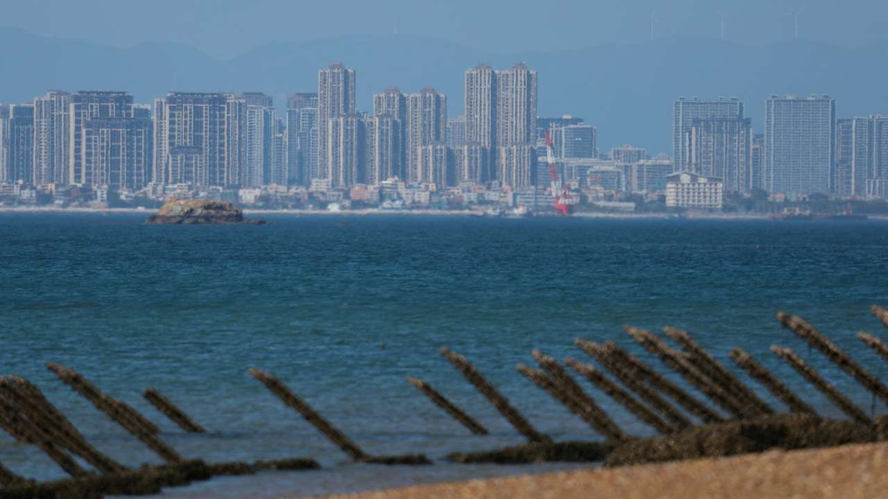 FILE PHOTO: Anti-landing barricades are pictured on the beach, with China's Xiamen city in the background, in Kinmen