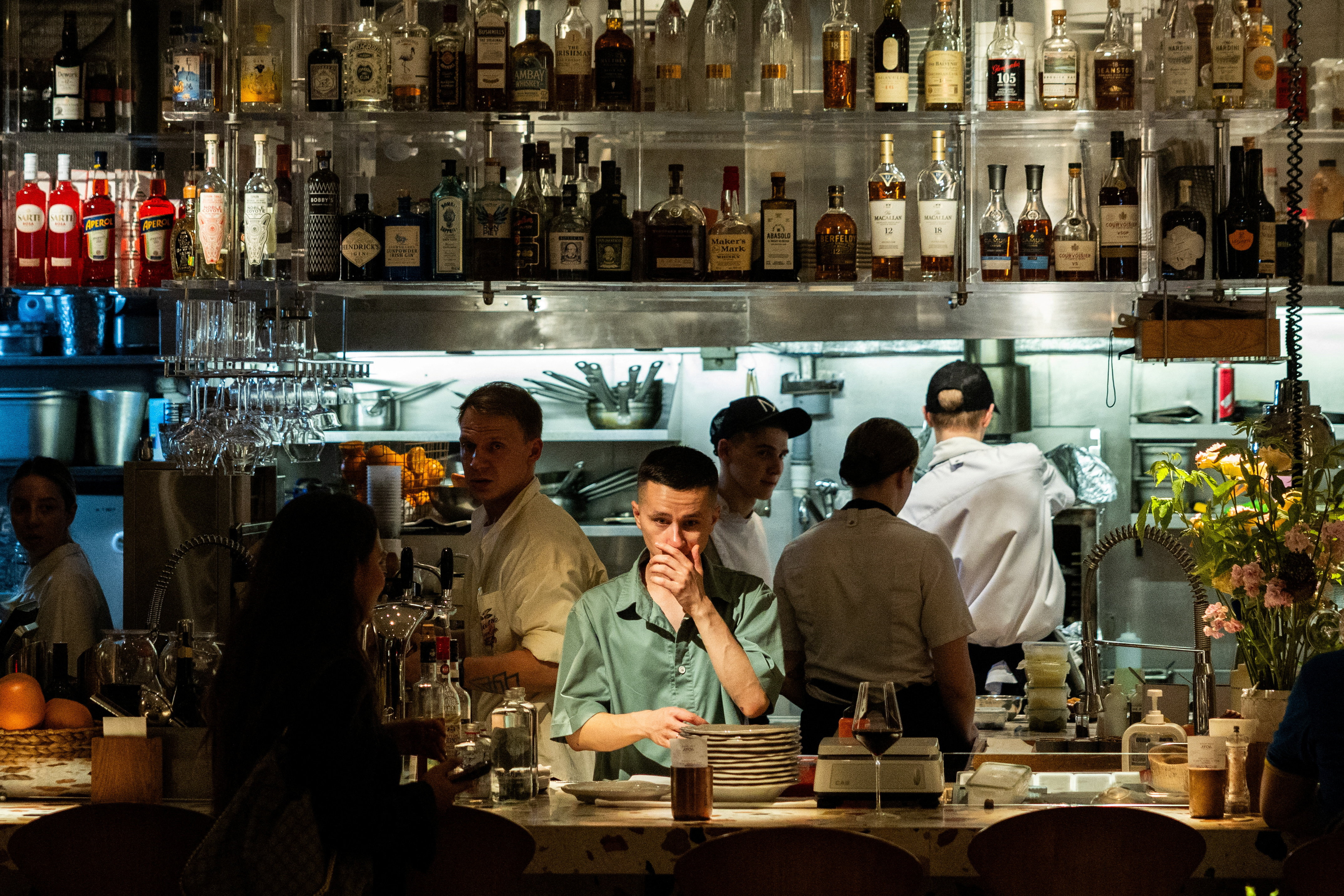 Employees work in the open kitchen of a restaurant in the Patriarch's Ponds neighbourhood in Moscow