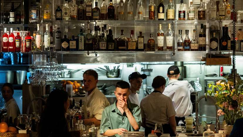 Employees work in the open kitchen of a restaurant in the Patriarch's Ponds neighbourhood in Moscow