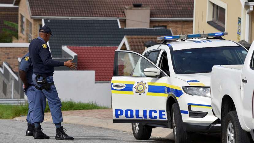 Police officers inspect the scene where kidnapped U.S. pastor, Josh Sullivan, was rescued last night in a shootout during which three suspects were killed, in KwaMagxaki