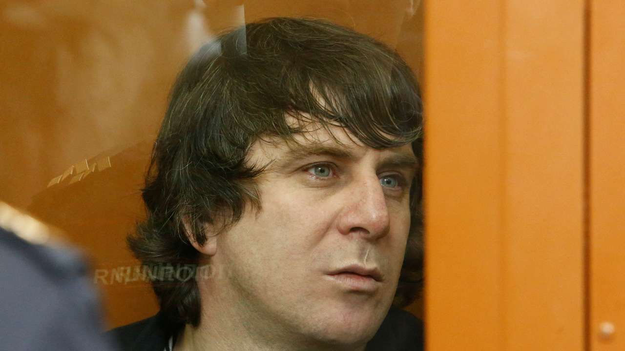 FILE PHOTO: Eskerkhanov, who is suspected of involvement in the killing of opposition figure Nemtsov, sits inside a glass-walled cage during their trial at the Moscow military district court