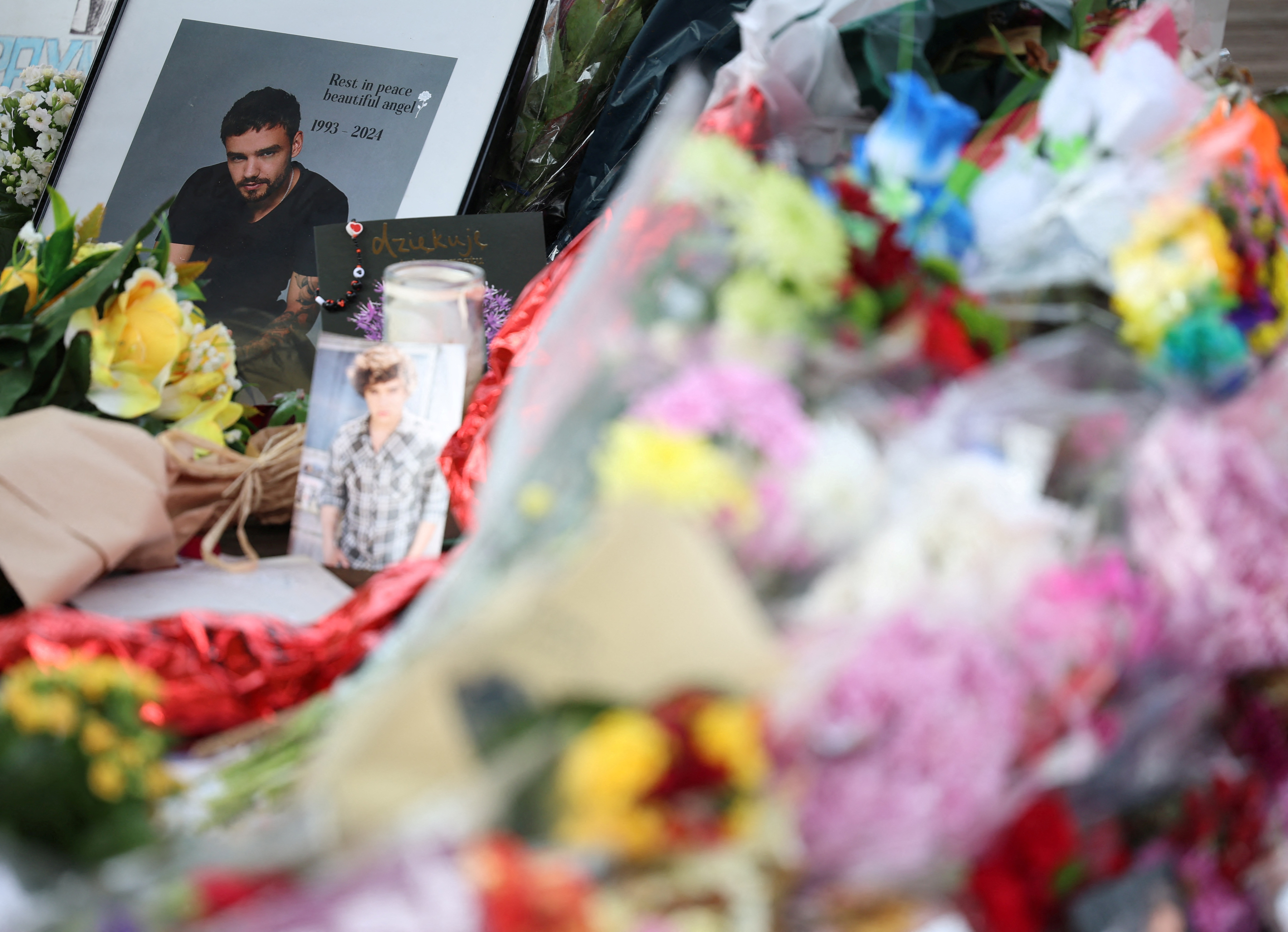 FILE PHOTO: Flowers and tributes to remember former One Direction singer Liam Payne, who was found dead after he fell from a third-floor hotel room balcony in Buenos Aires, are seen in a park in his home town of Wolverhampton, Britain