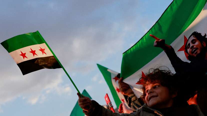 People gather during a celebration called by Hayat Tahrir al-Sham (HTS) after the ousting of Syria's Bashar al-Assad, in Damascus