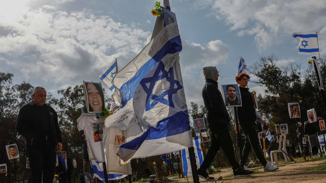 People walk at the site of the Nova festival, where people were killed and kidnapped during the October 7 attack by Hamas gunmen from Gaza, in Reim