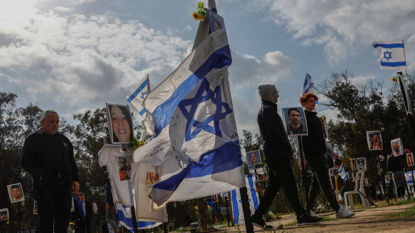 People walk at the site of the Nova festival, where people were killed and kidnapped during the October 7 attack by Hamas gunmen from Gaza, in Reim
