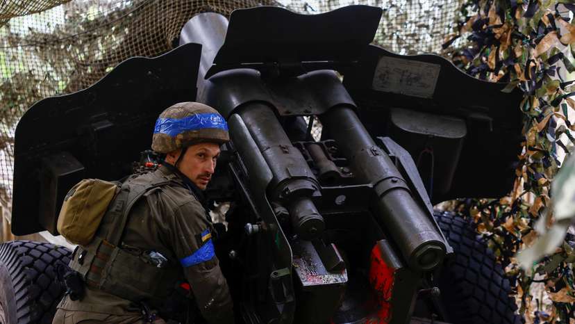 Ukrainian National Guard 'Khartiia' brigade service member and a D-20 howitzer crew commander Ivan Liashko prepares to fire towards Russian troops in a front line in Kharkiv region