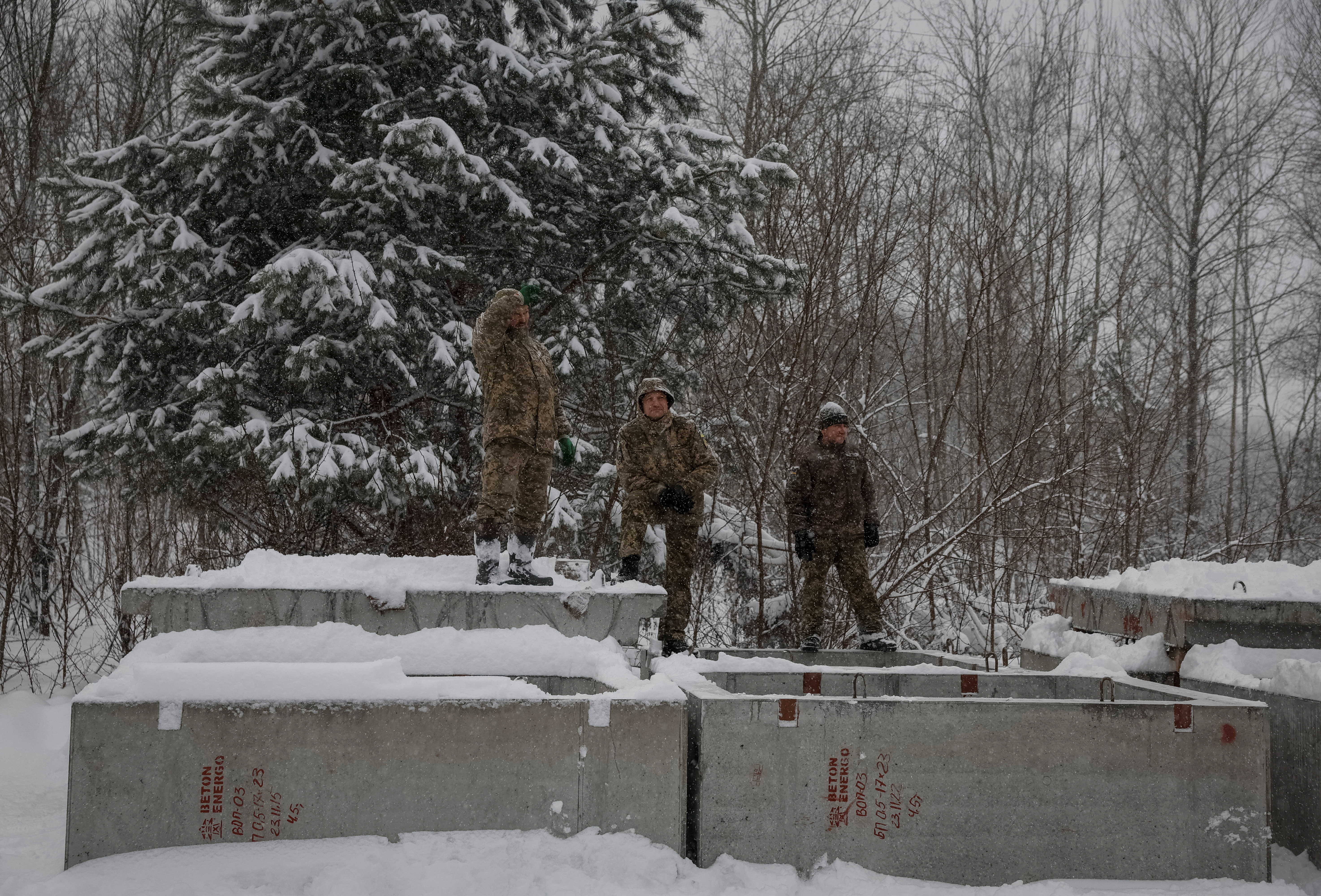 Ukrainian soldiers rest as they construct shelters for new defensive line near Belarus border in Chornobyl exclusion zone