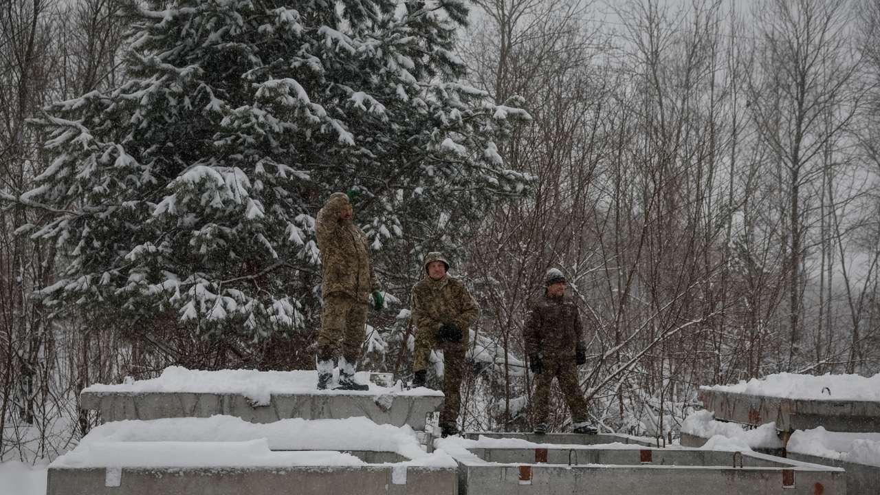 Ukrainian soldiers rest as they construct shelters for new defensive line near Belarus border in Chornobyl exclusion zone