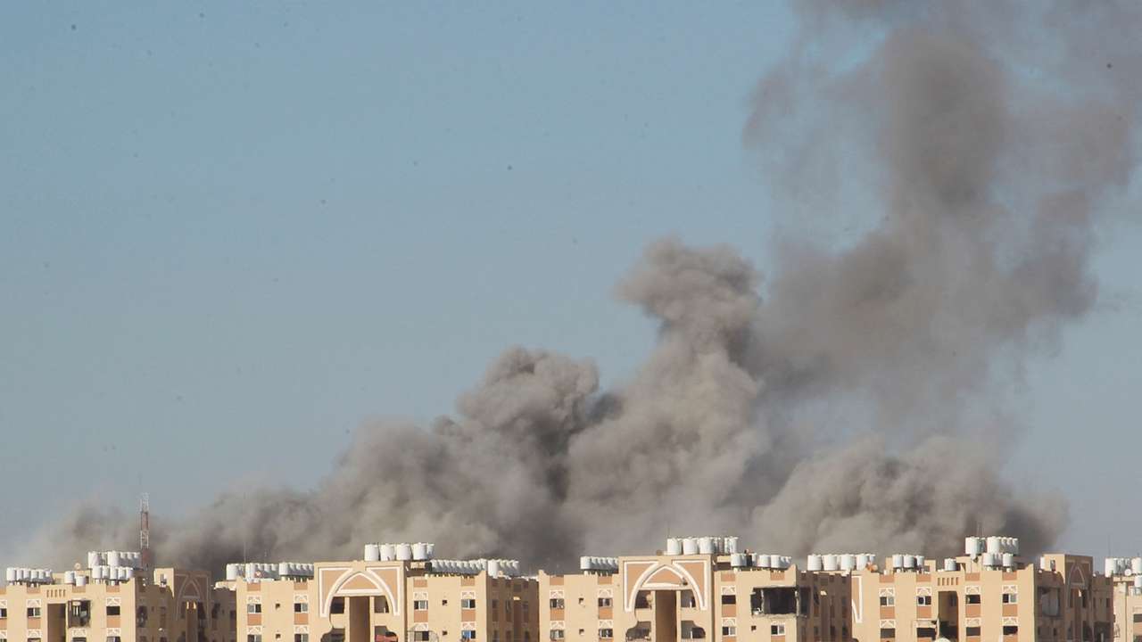 Smoke rises following an Israeli strike on a residential building, in Khan Younis