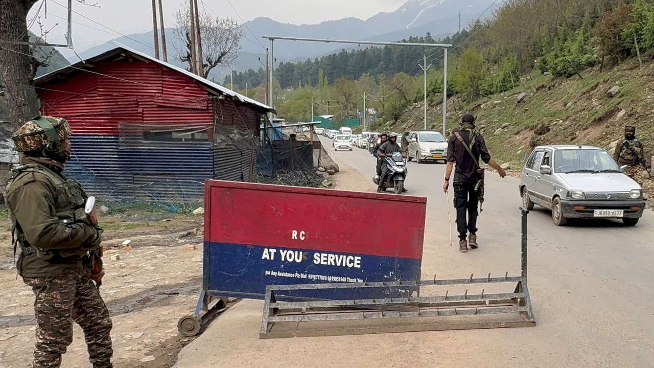 Indian police officers stop vehicles at a check point following a suspected militant attack, near Pahalgam in south Kashmir's Anantnag district