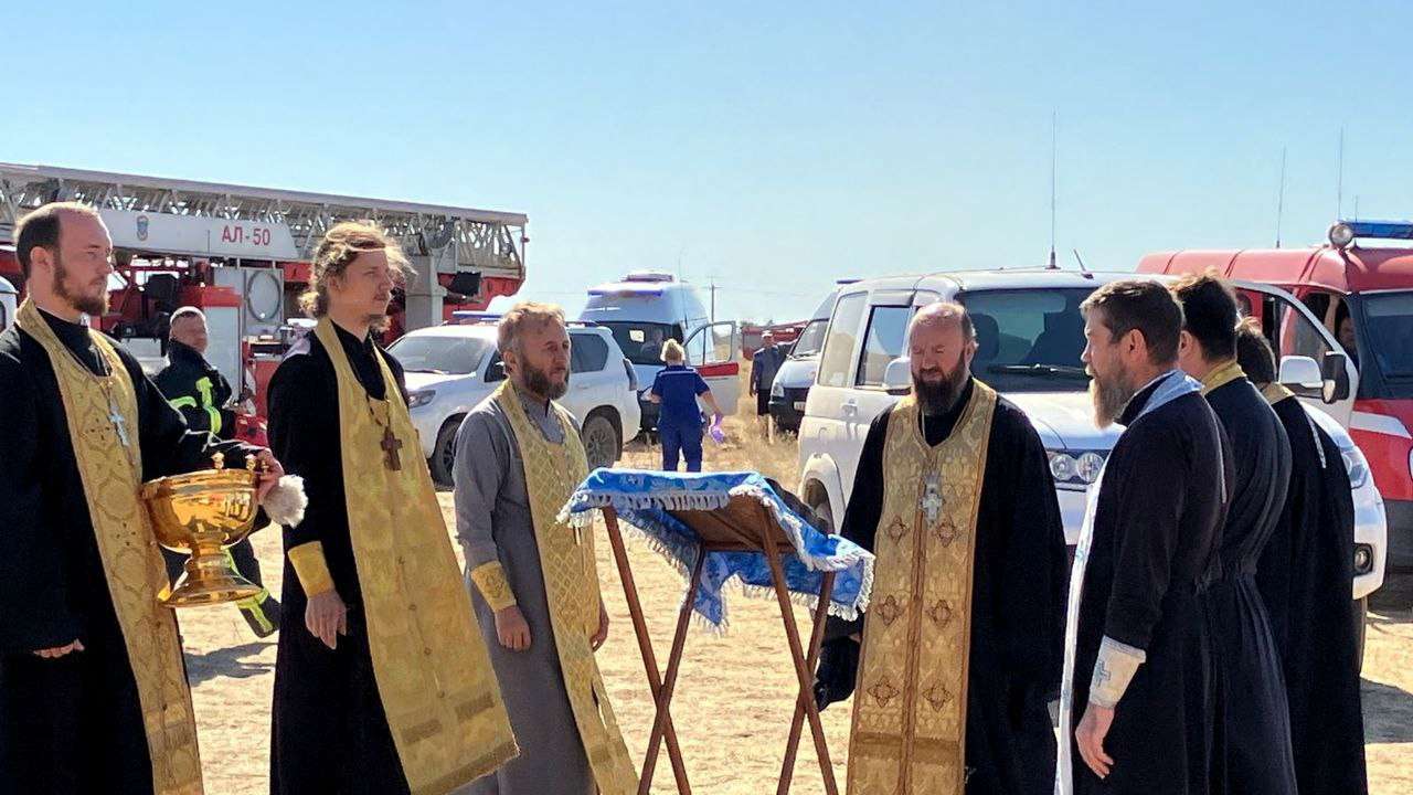 Russian priests bring icon to try to tame depot fire after drone attack