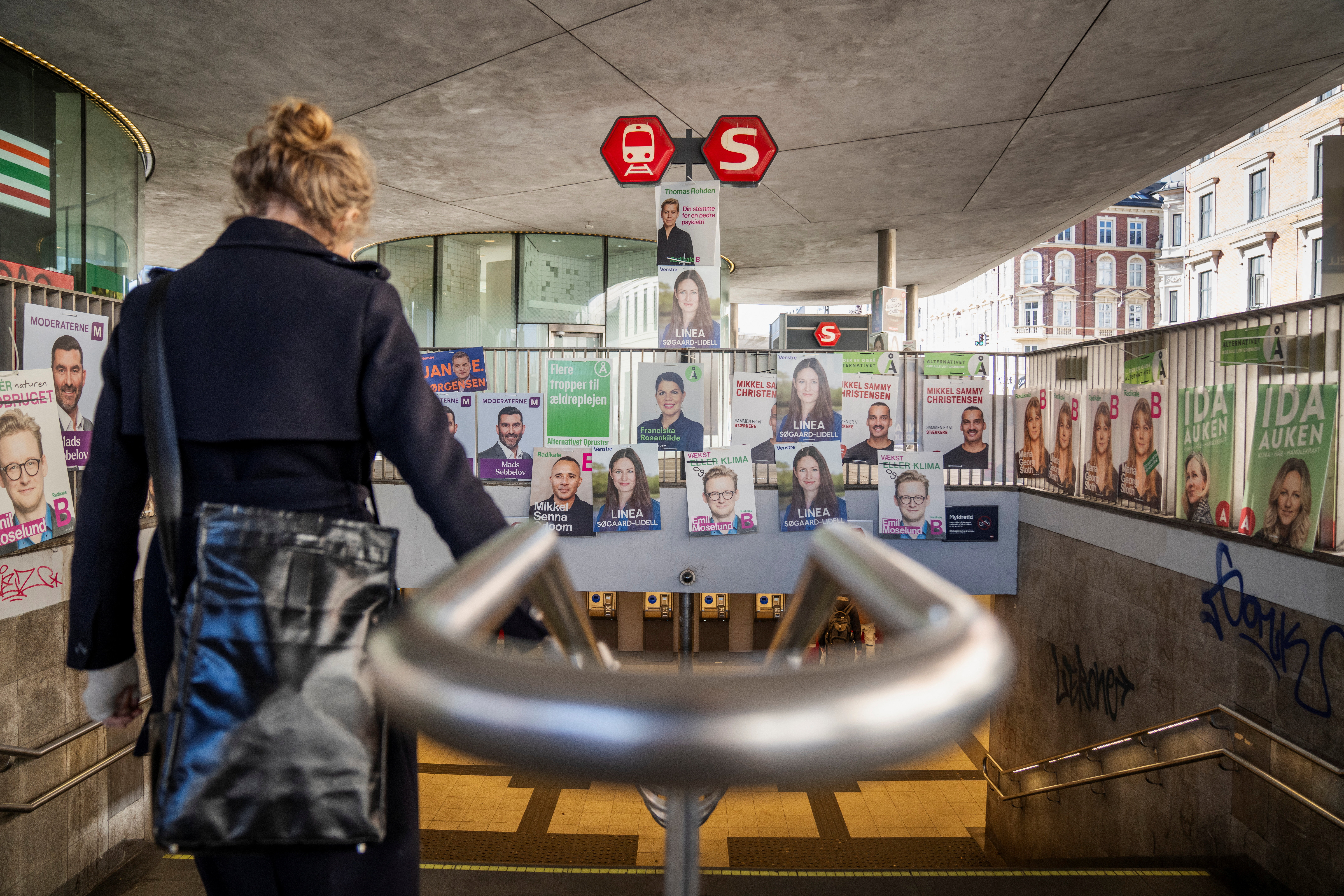 Election posters hang above the entrance of Noerreport Station in Copenhagen