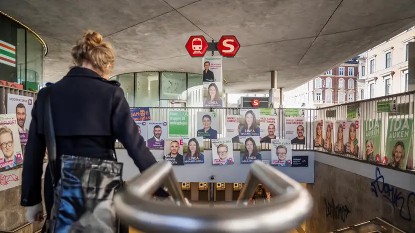 Election posters hang above the entrance of Noerreport Station in Copenhagen