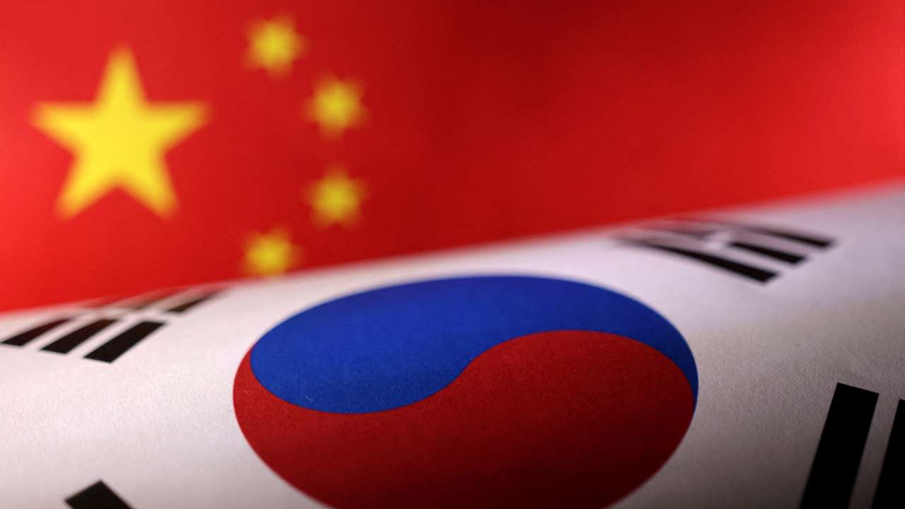 Illustration shows printed Chinese and South Korean flags