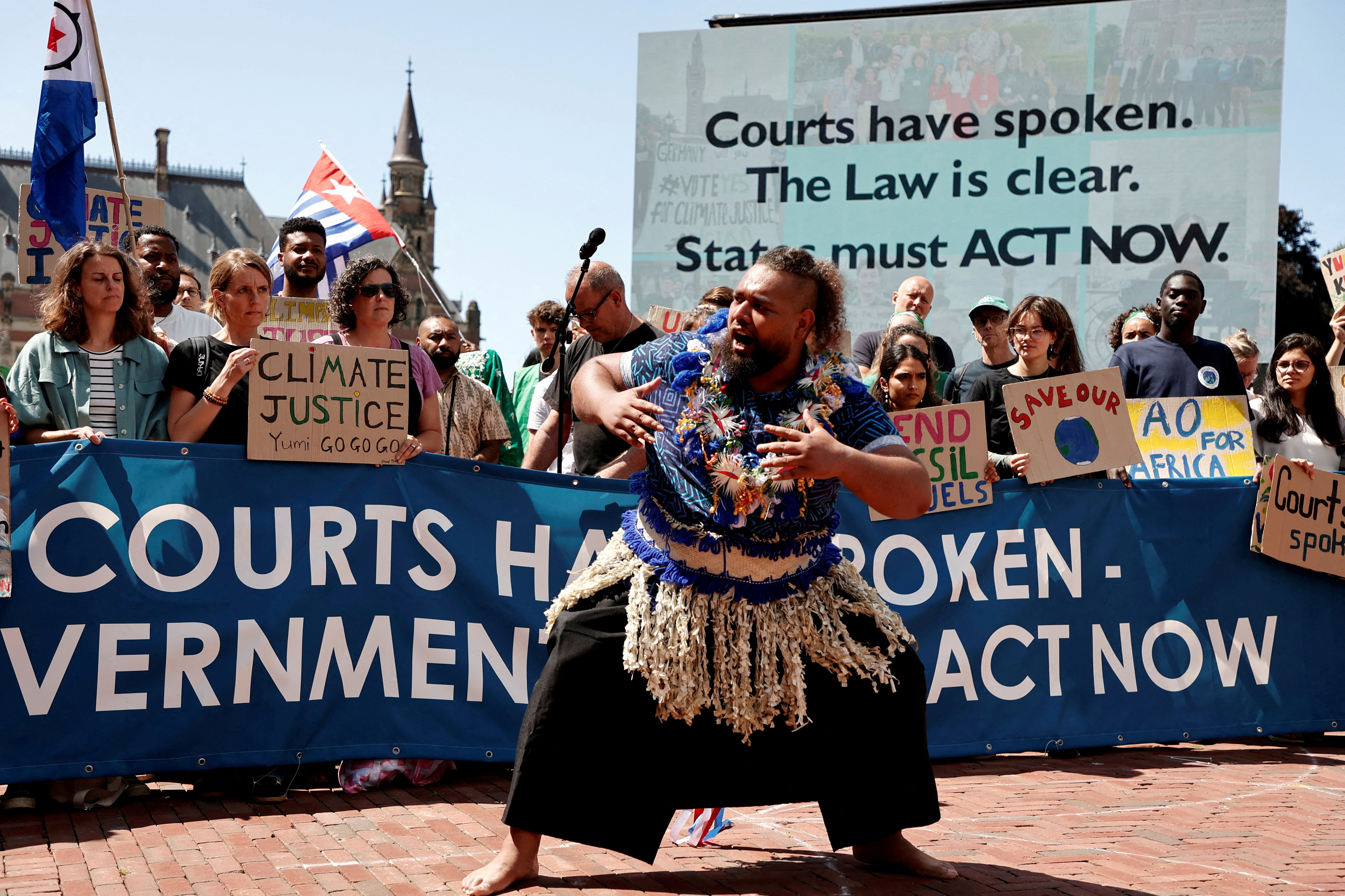 FILE PHOTO: Climate activists and campaigners demonstrate outside the International Court of Justice (ICJ) in The Hague