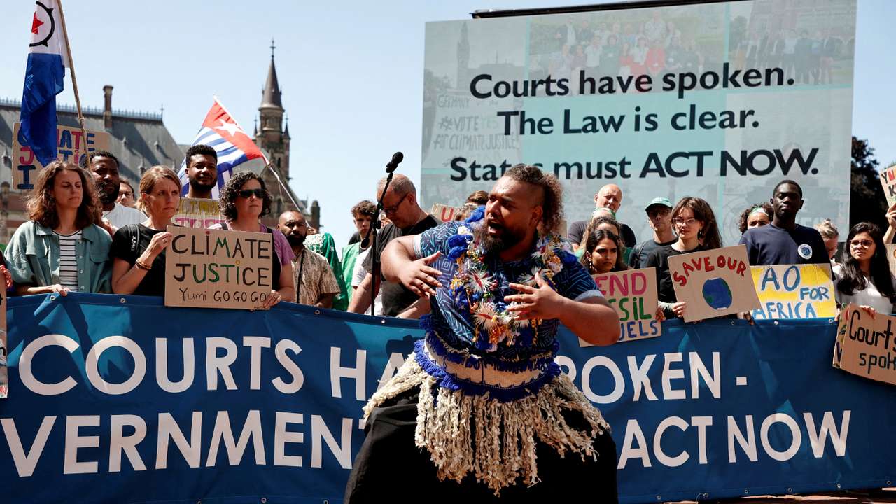 FILE PHOTO: Climate activists and campaigners demonstrate outside the International Court of Justice (ICJ) in The Hague