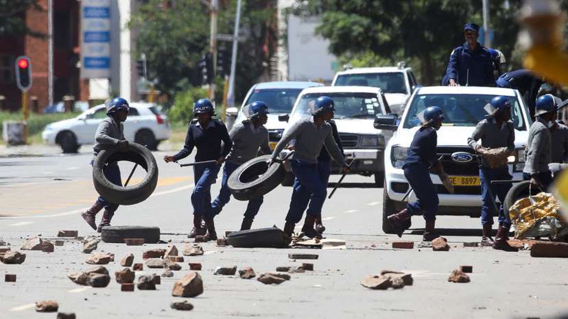 Clashes between anti-riot police and protesters, in Harare