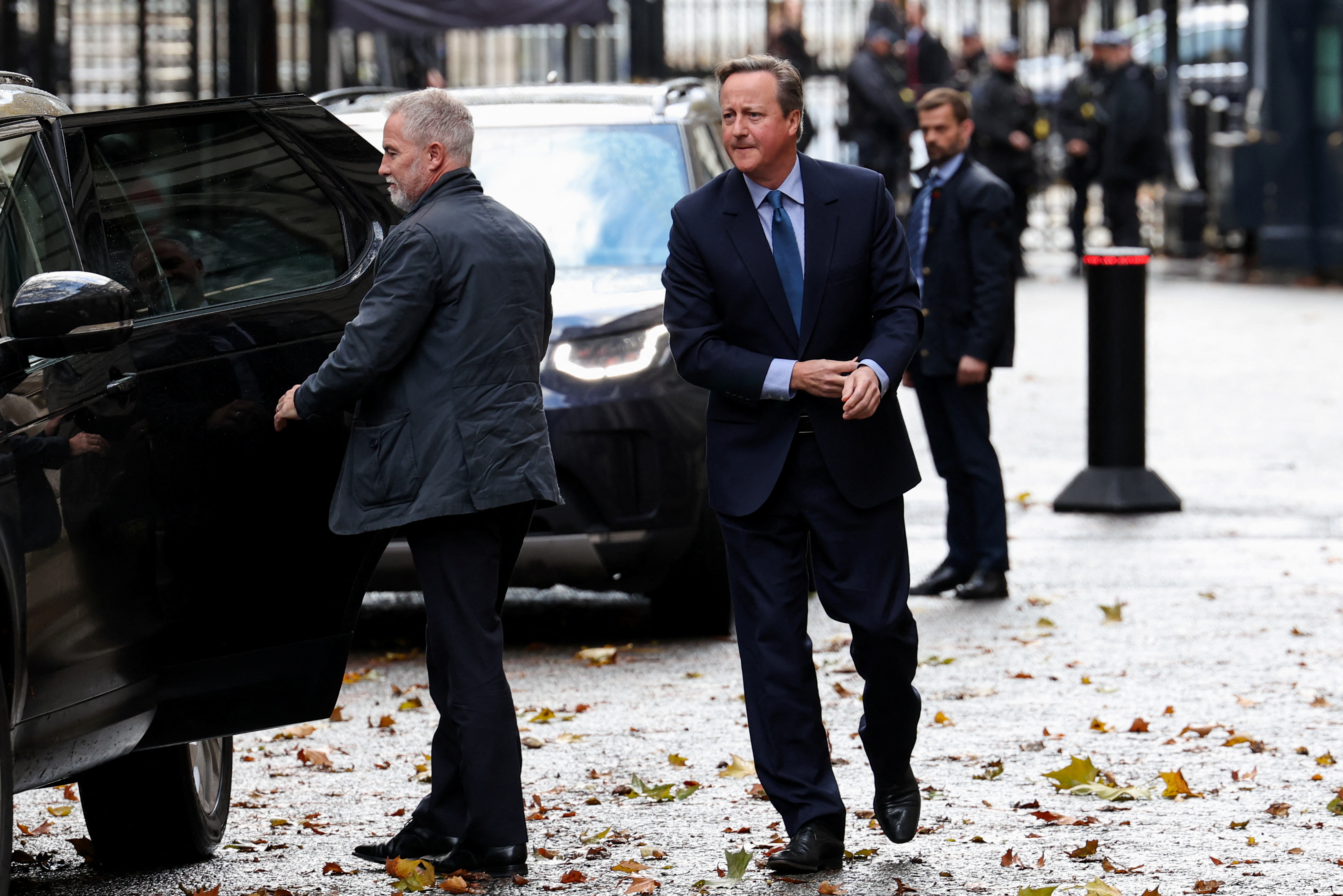 Former British Prime Minister David Cameron walks outside 10 Downing Street in London