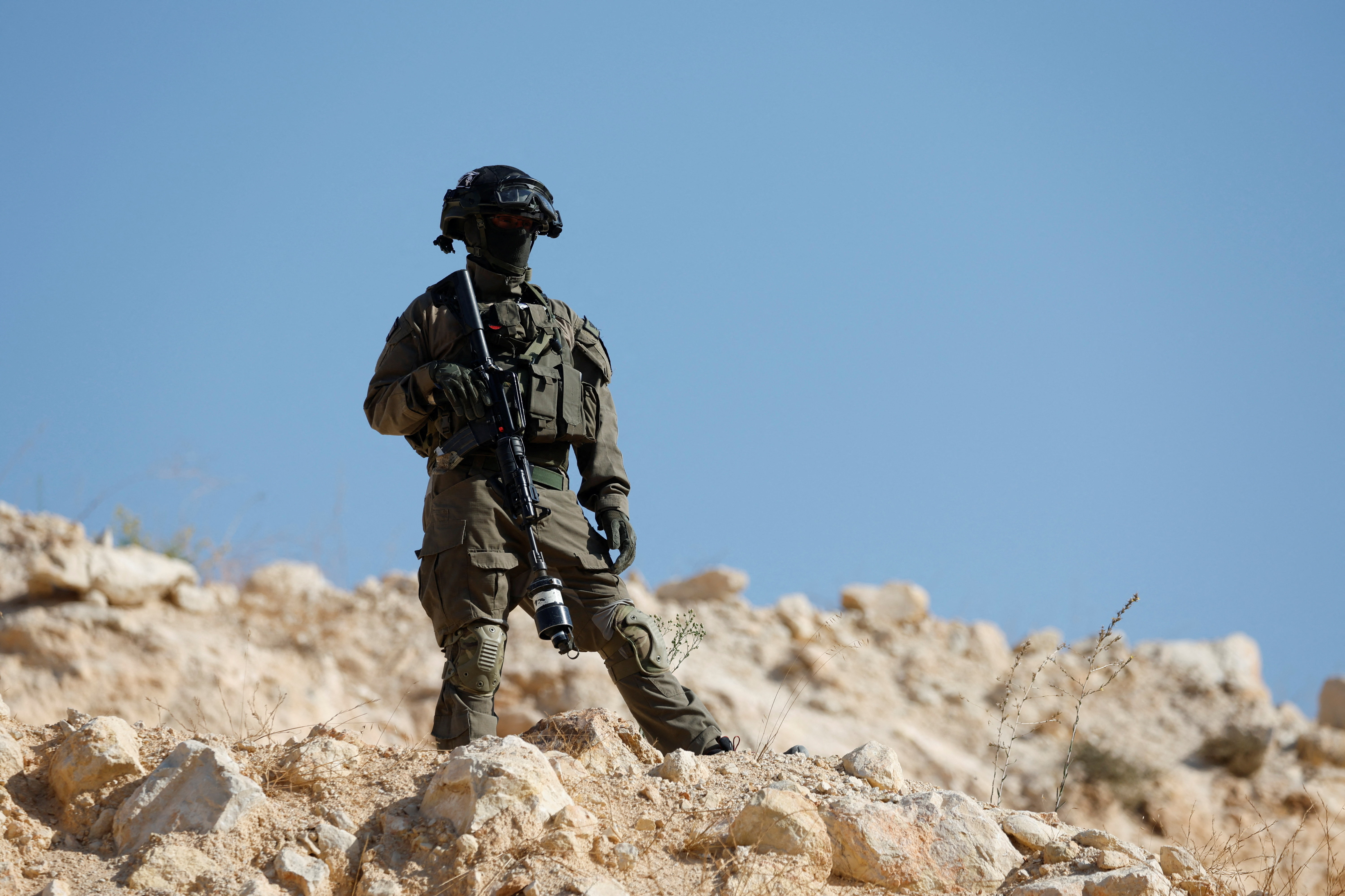 Israeli forces block the access of Palestinians and foreign activists to olive trees during the olive harvest near Hebron