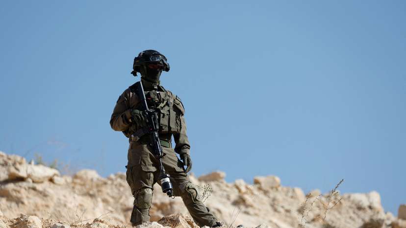 Israeli forces block the access of Palestinians and foreign activists to olive trees during the olive harvest near Hebron