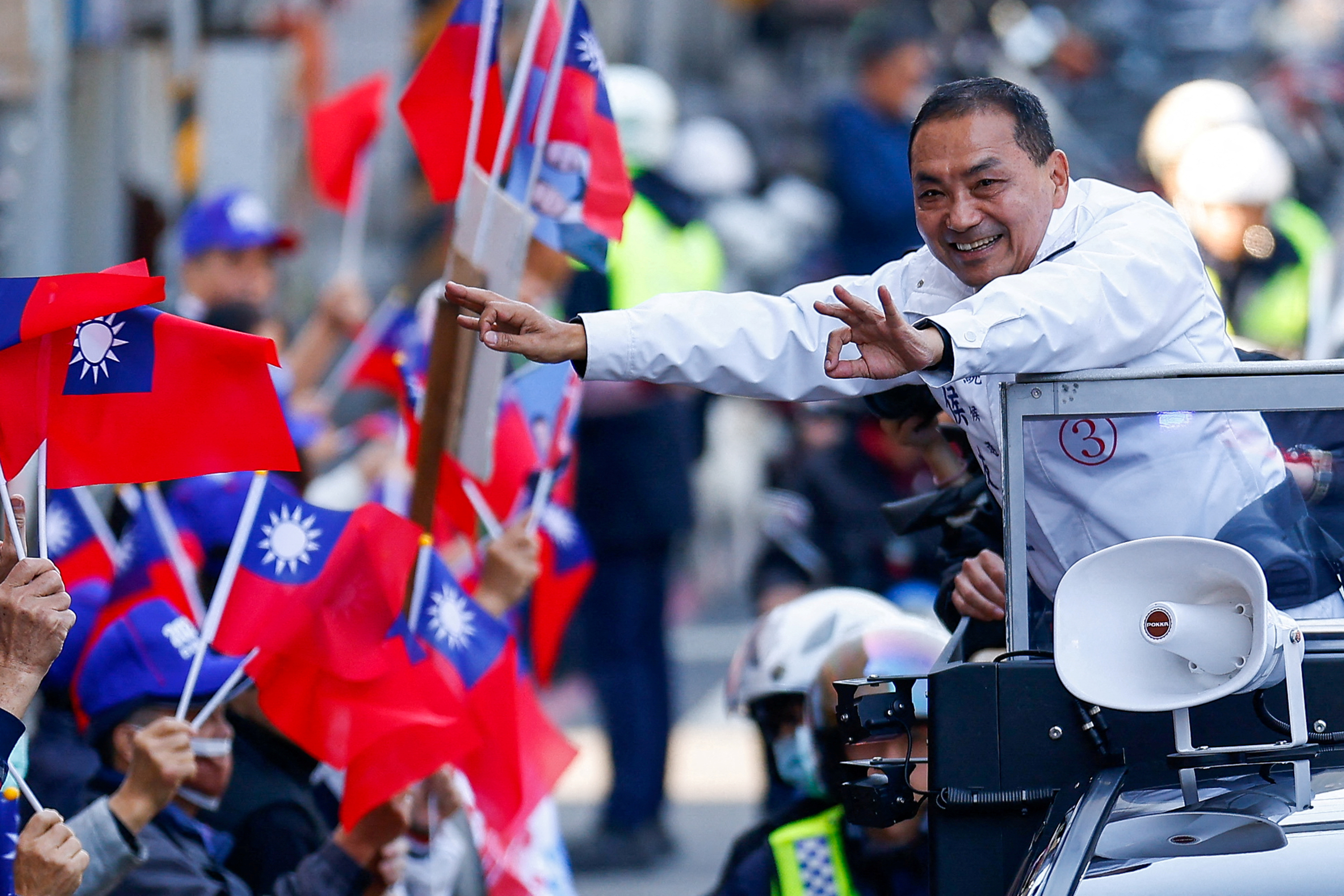 FILE PHOTO: Hou Yu-ih, a candidate for Taiwan's presidency from the main opposition party Kuomintang (KMT), gestures to his supporters