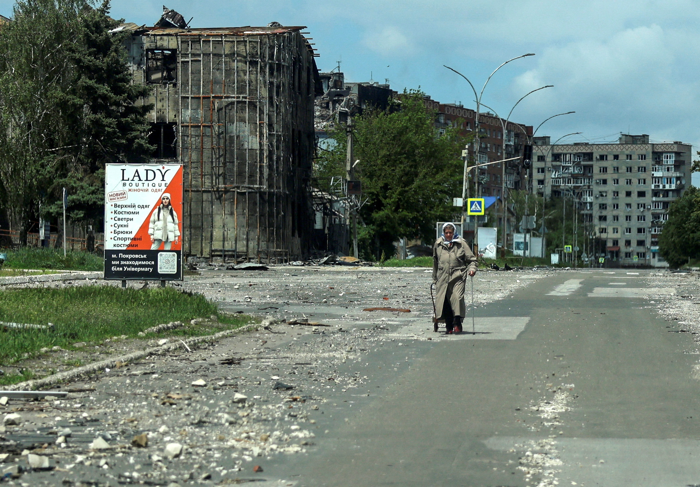 FILE PHOTO: A resident walks at a street near buildings in the frontline town of Pokrovsk