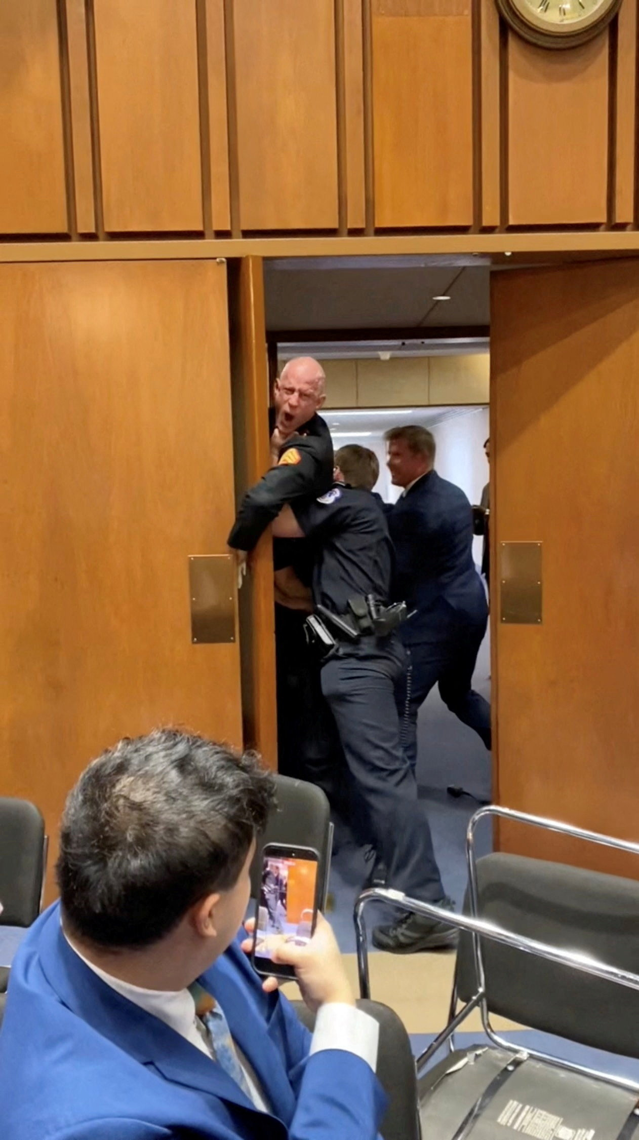 Former Marine Brian McGinnis is dragged out during the Senate Armed Services subcommittee hearing, in Washington