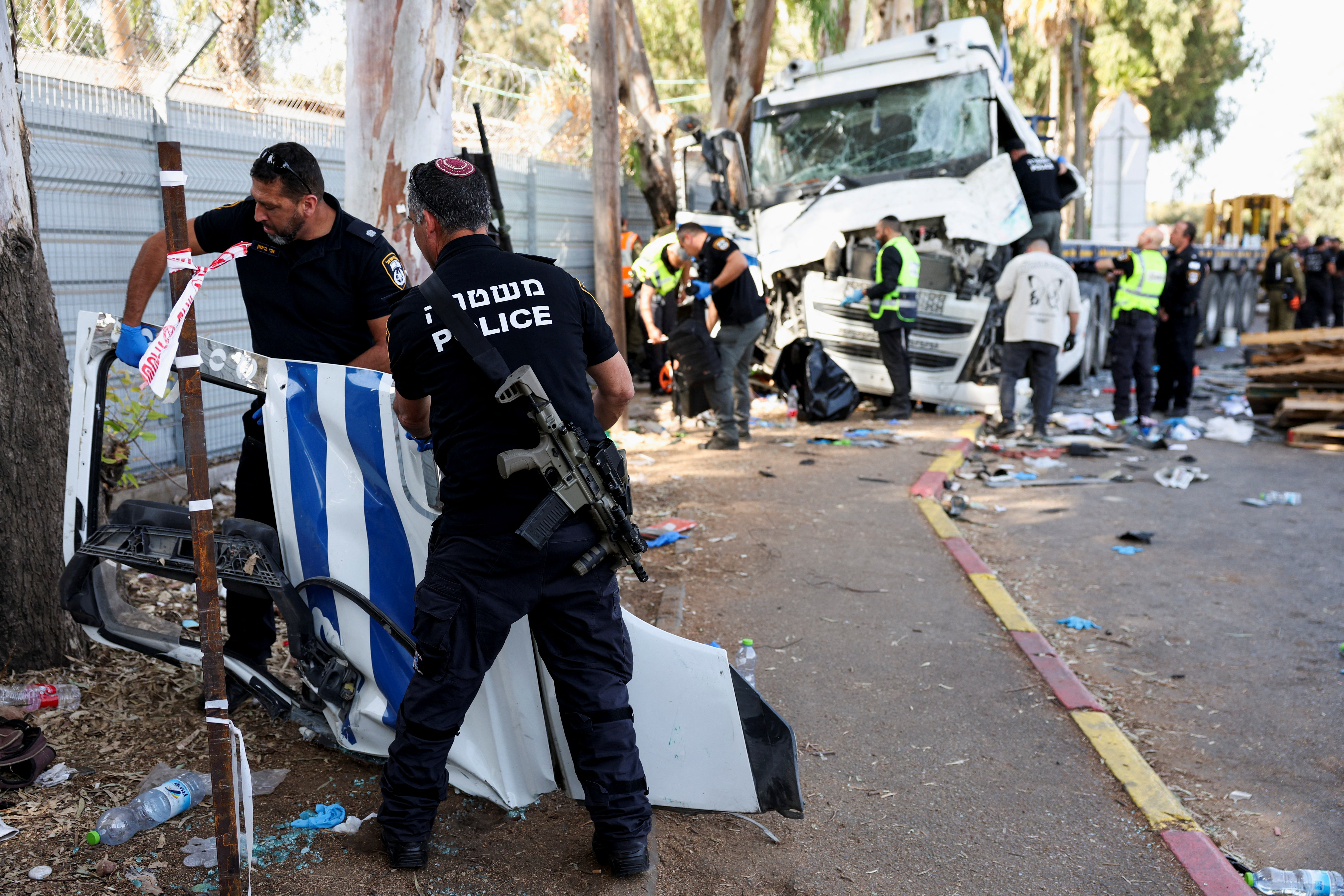 Israeli emergency services work at the scene where a truck rammed into pedestrians at a bus stop, in Ramat Hasharon