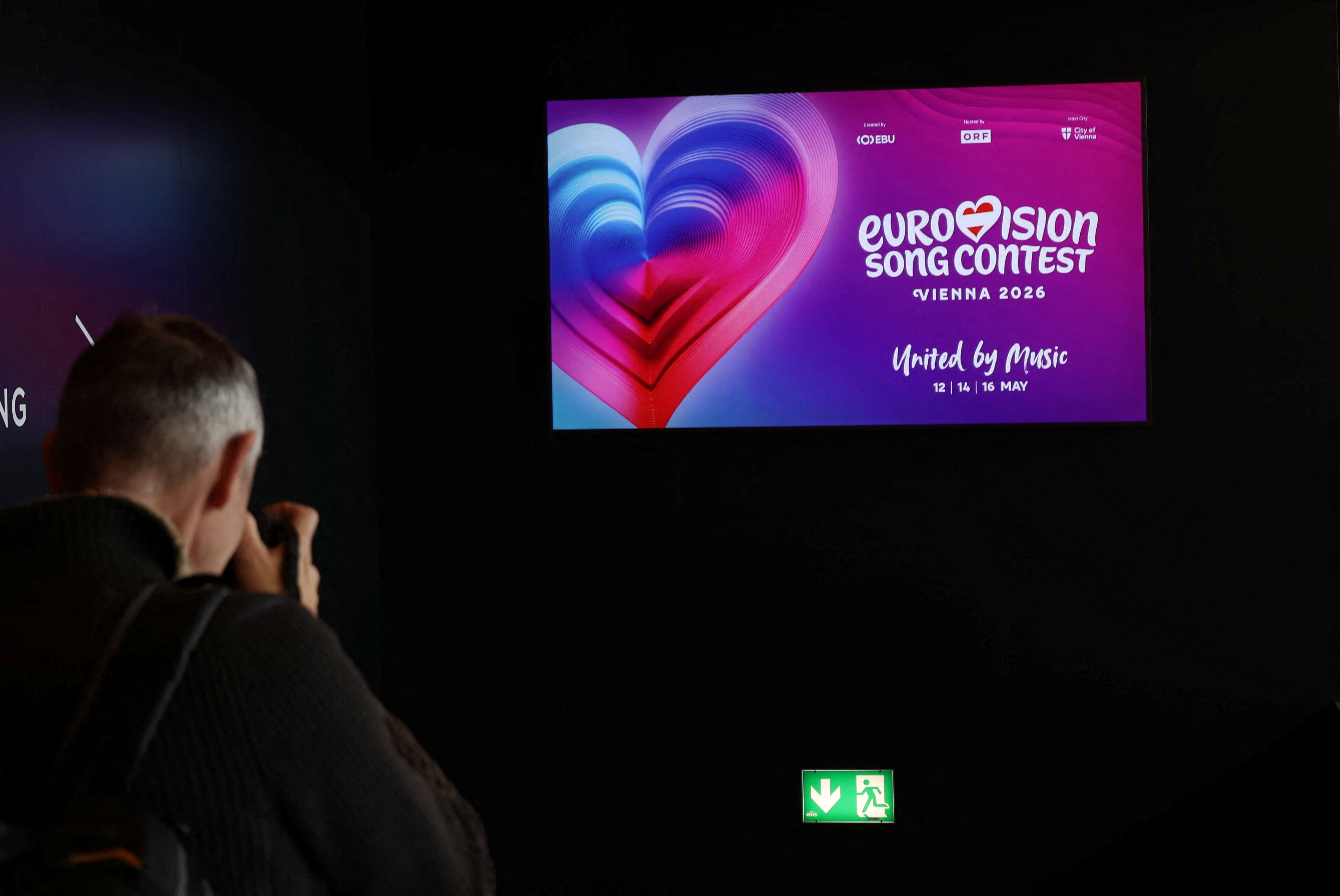 FILE PHOTO: A photographer takes a picture of a TV screen in Wiener Stadthalle, the venue of next year's Eurovision in Vienna