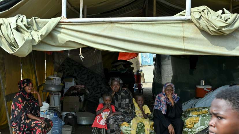 Displaced people sit inside a tent at a school turned into a shelter, in Port Sudan
