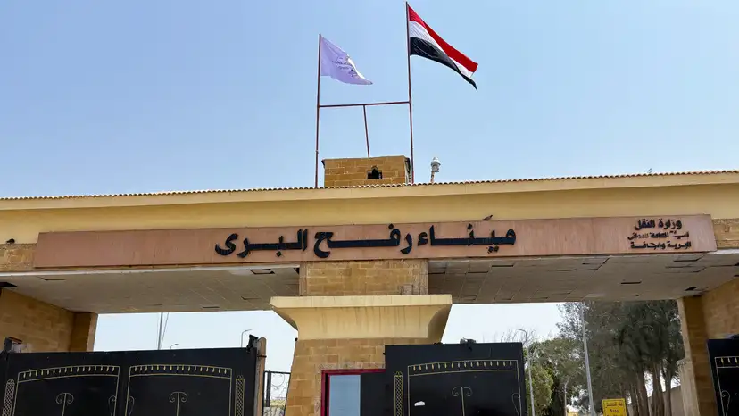 People stand at the Rafah border crossing between Egypt and the Gaza Strip, in Rafah