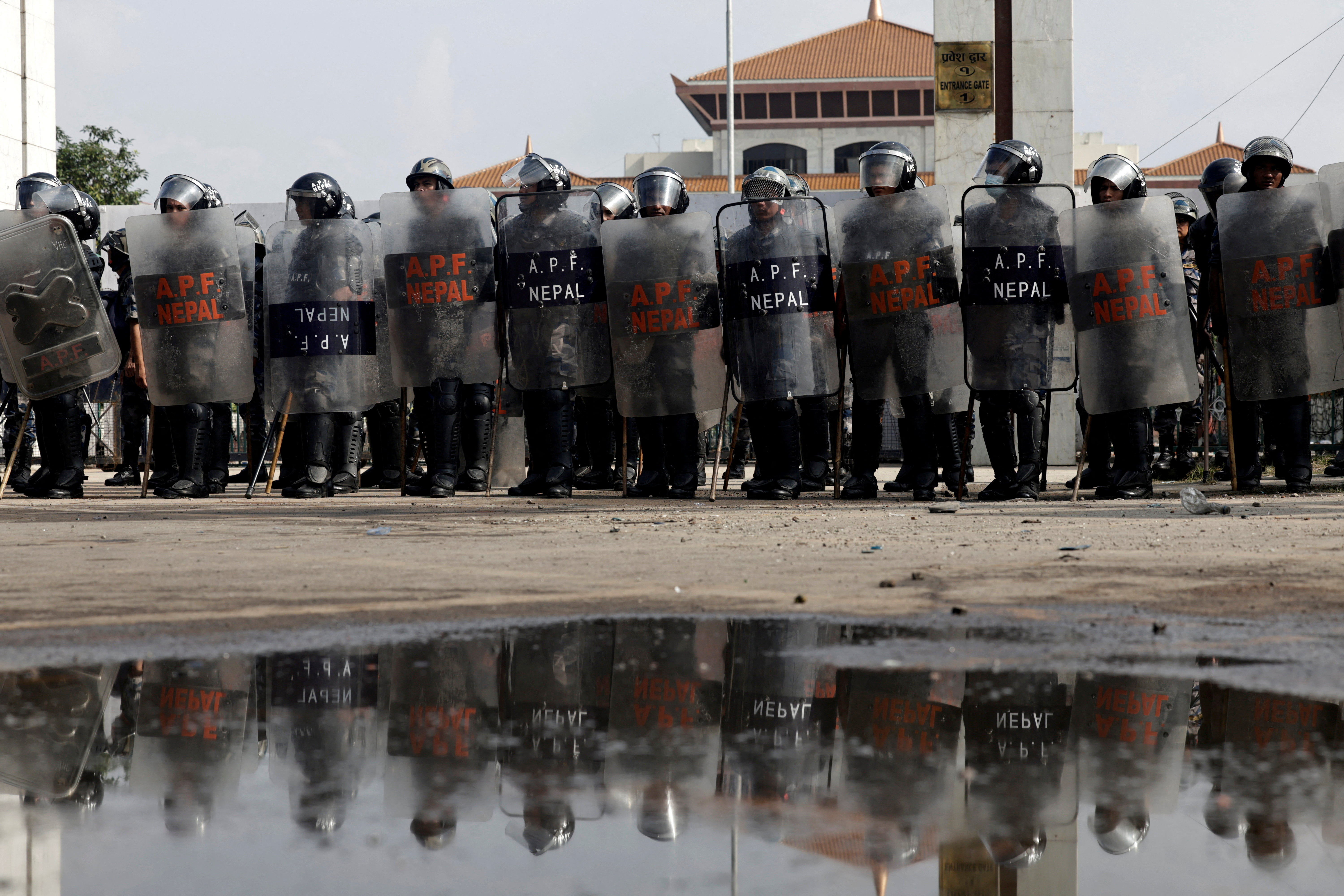 FILE PHOTO: Police officers in riot gear stand guard outside the Parliament during a curfew, in Kathmandu
