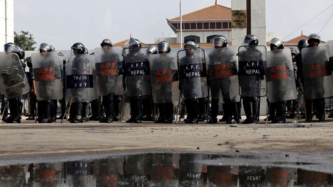FILE PHOTO: Police officers in riot gear stand guard outside the Parliament during a curfew, in Kathmandu
