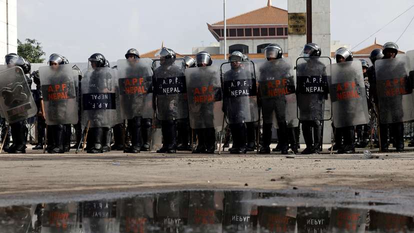 FILE PHOTO: Police officers in riot gear stand guard outside the Parliament during a curfew, in Kathmandu