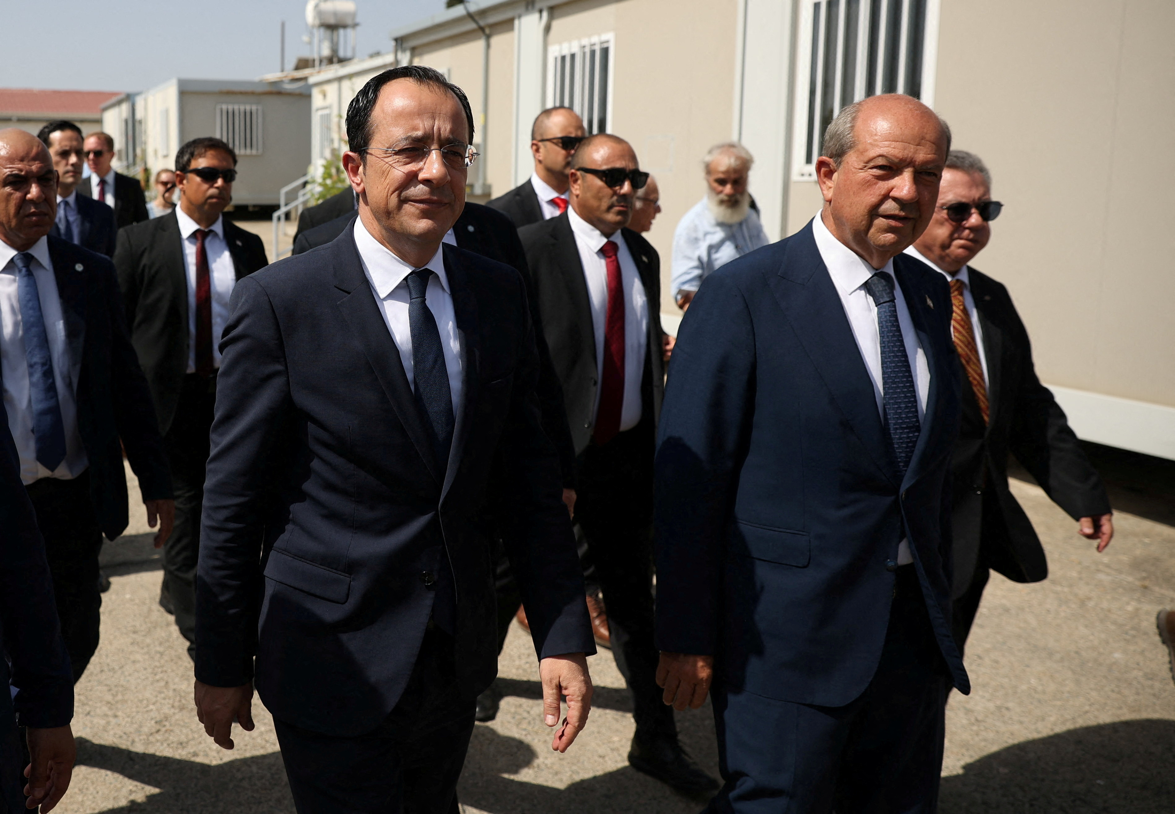 FILE PHOTO: Cyprus President Nikos Christodoulides and Turkish Cypriot leader Ersin Tatar, walk during a visit at the the CMP Anthropological Laboratory in the buffer zone of Nicosia airport