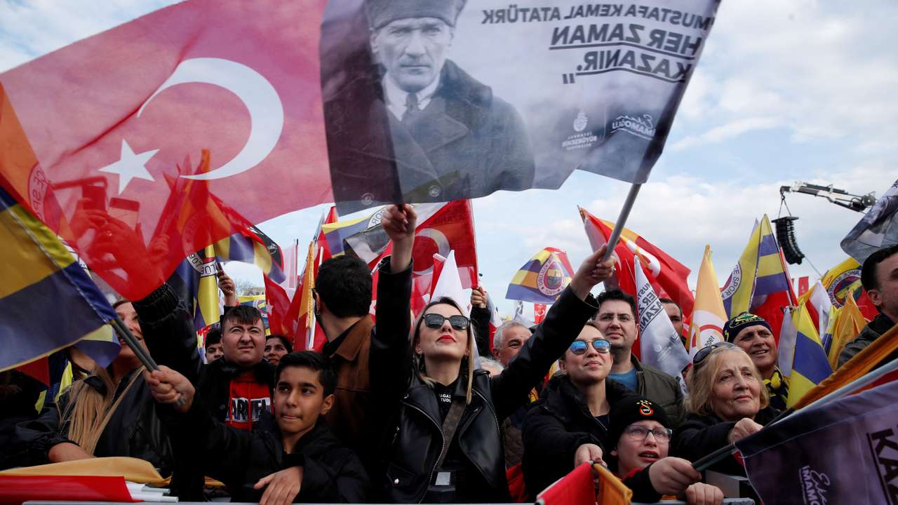 People wave flags in support of Turkish soccer teams Fenerbahce and Galatasaray during a gathering in Istanbul