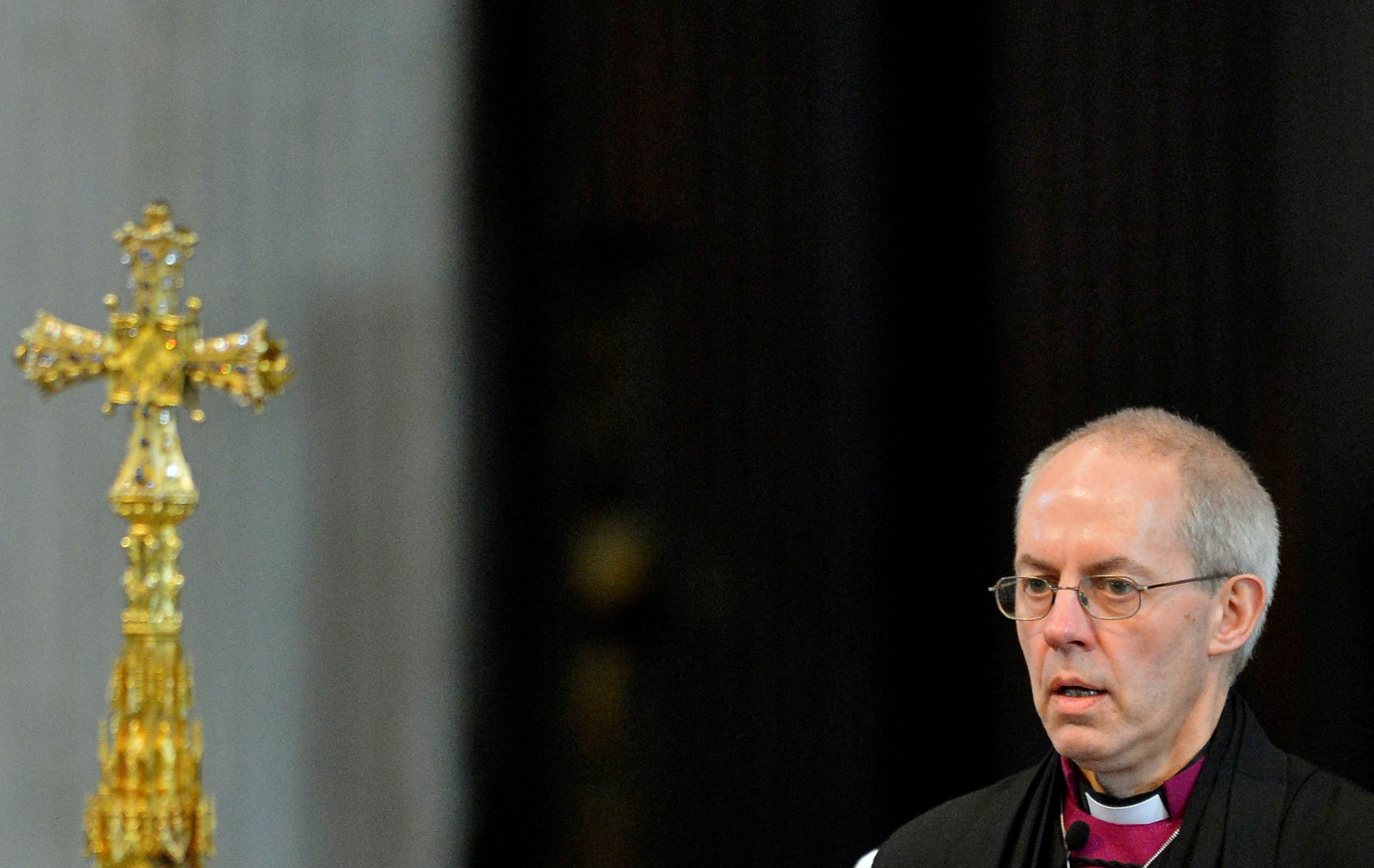 FILE PHOTO: File photograph shows Justin Welby, the new Archbishop of Canterbury, leaving at the close of the ceremony to confirm his election as Archbishop, at St Paul's Cathedral in London
