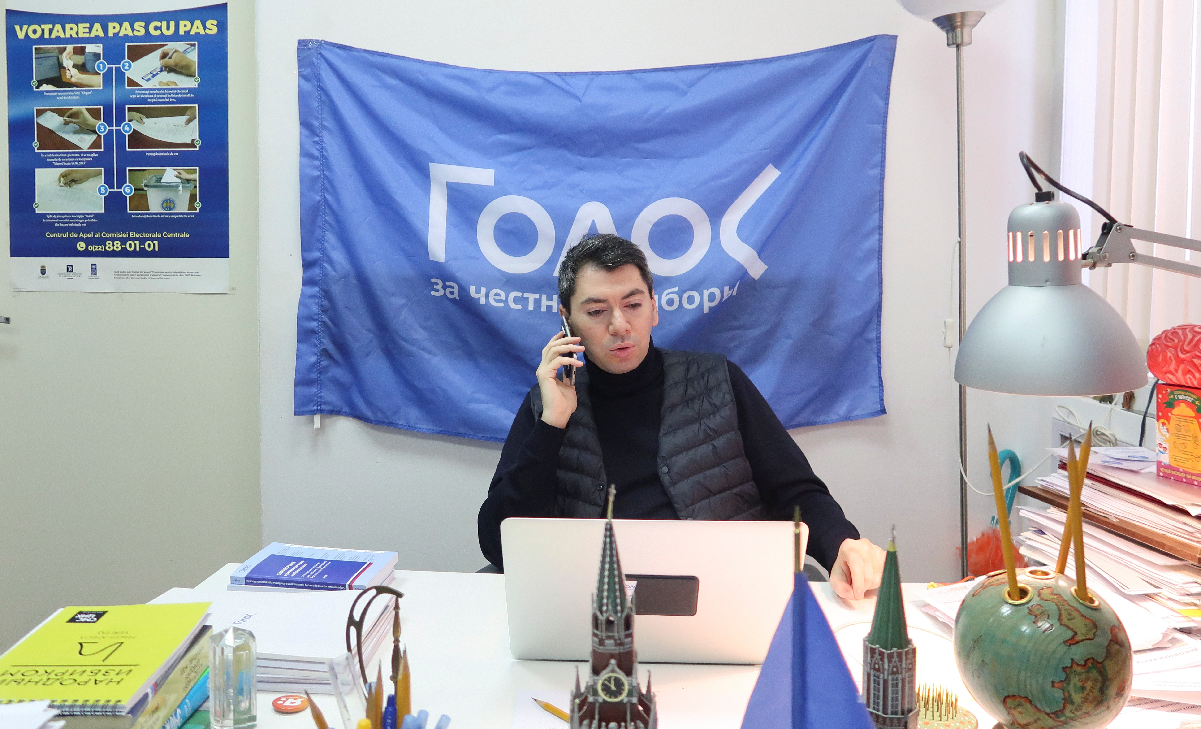Co-chairman of Golos non-governmental organisation Melkonyants speaks on the phone at his office in Moscow