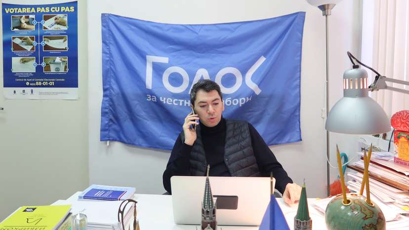 Co-chairman of Golos non-governmental organisation Melkonyants speaks on the phone at his office in Moscow