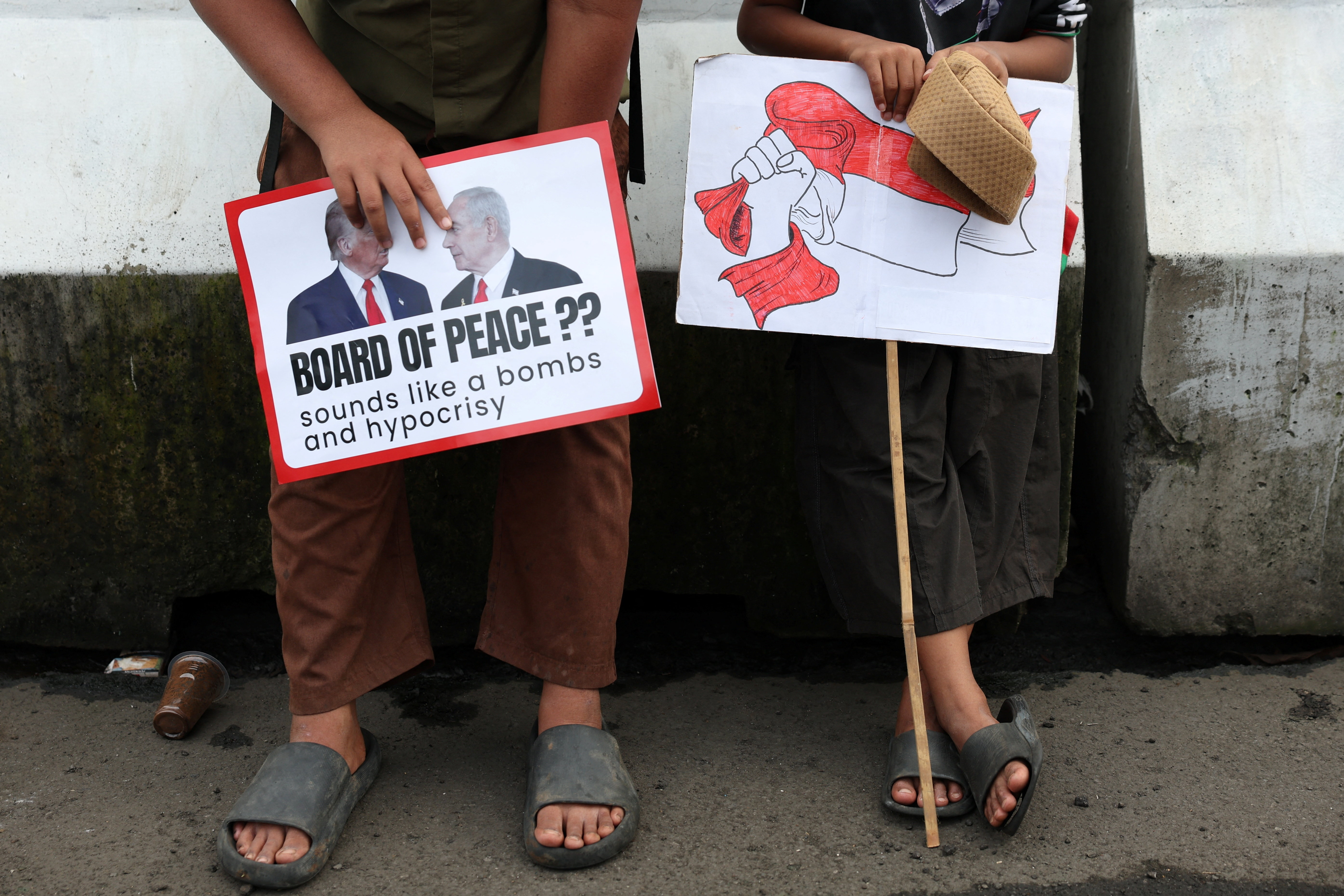 Boys in solidarity with Palestinians take part in a protest outside the U.S. embassy in Jakarta