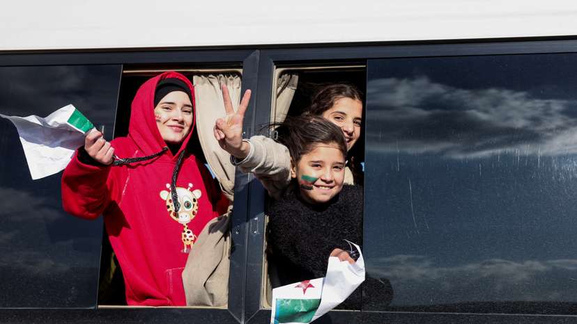 People celebrate after Syrian rebels announced that they have ousted President Bashar al-Assad, at Majdal Anjar in Bekaa