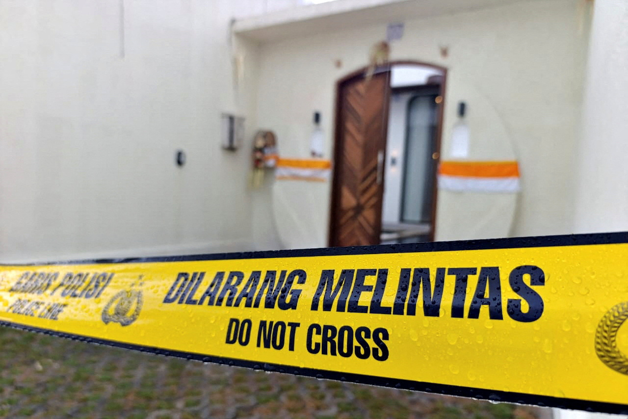A police line tape is seen outside the villa following a shooting incident in Badung