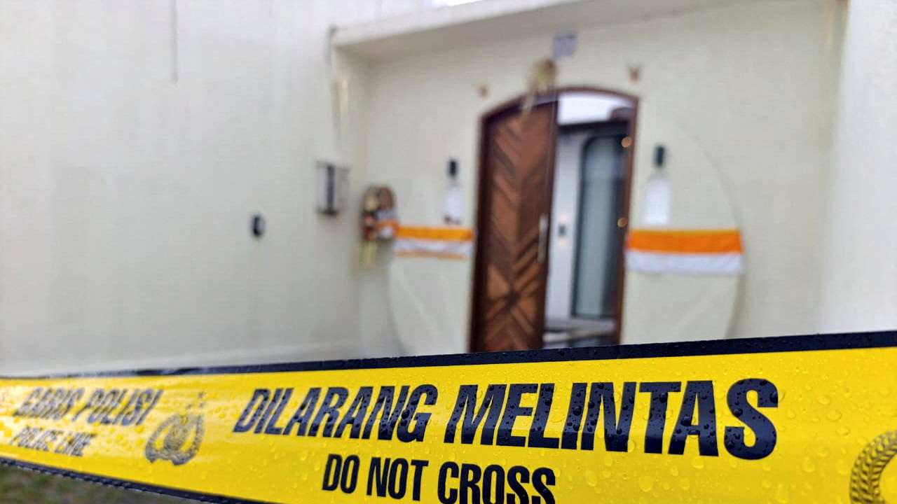 A police line tape is seen outside the villa following a shooting incident in Badung
