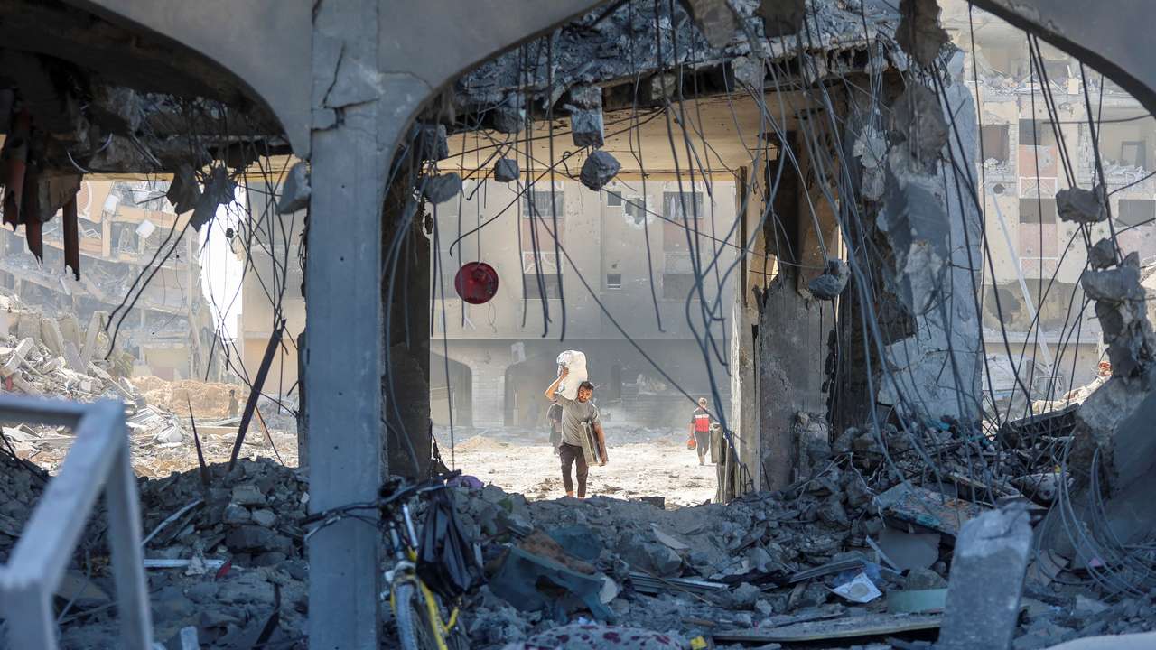 Palestinians inspect damages in Qatari-funded Hamad City following Israeli raid, in Khan Younis in the southern Gaza Strip