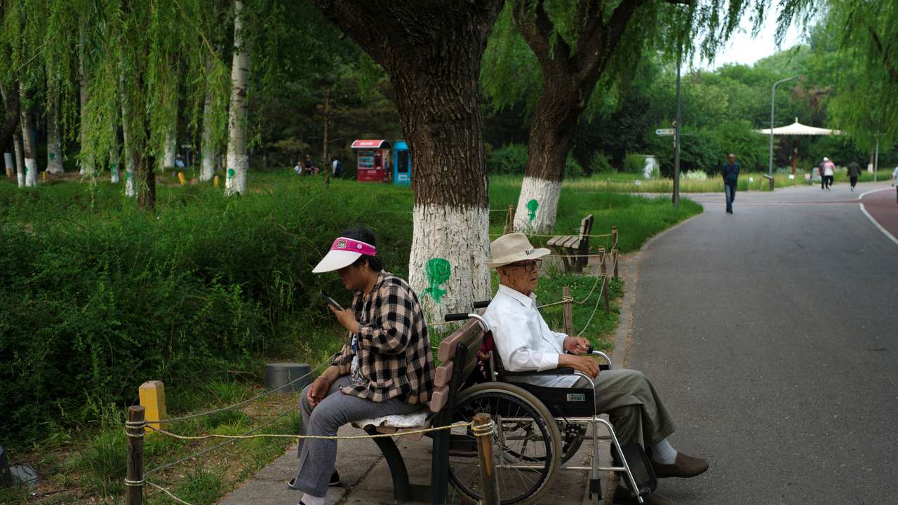 Elderly people rest at a park on a summer day in Beijing